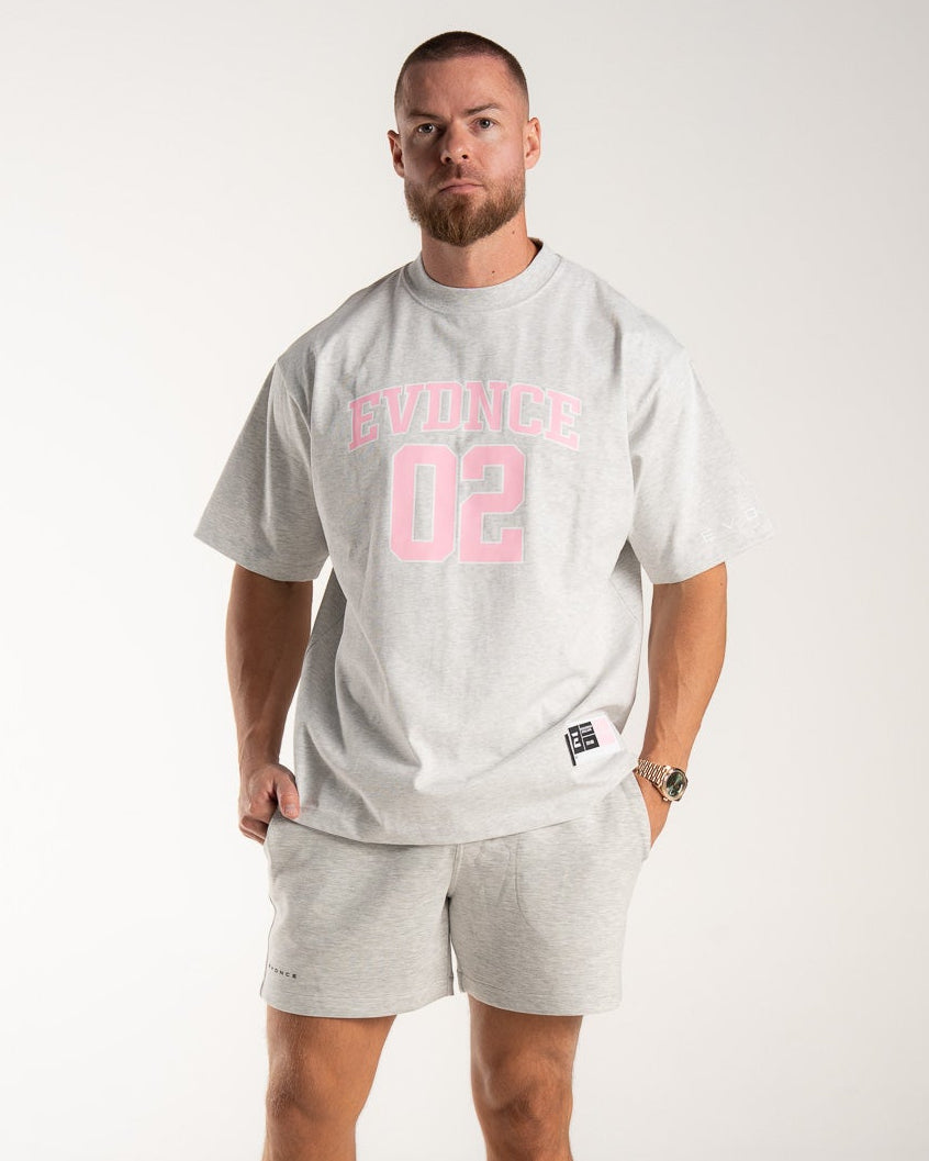 Man wearing a grey  marl'Evidence 02' t-shirt and shorts on a white background