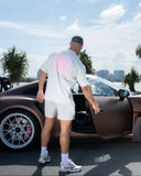 Man standing next to a luxury car with a cityscape in the background